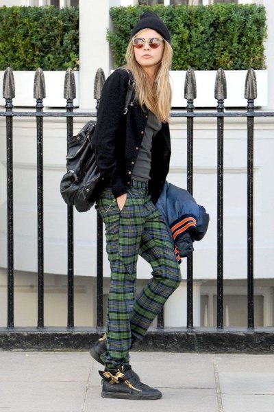 black bomber jacket with gray t-shirt and plaid flannel pants