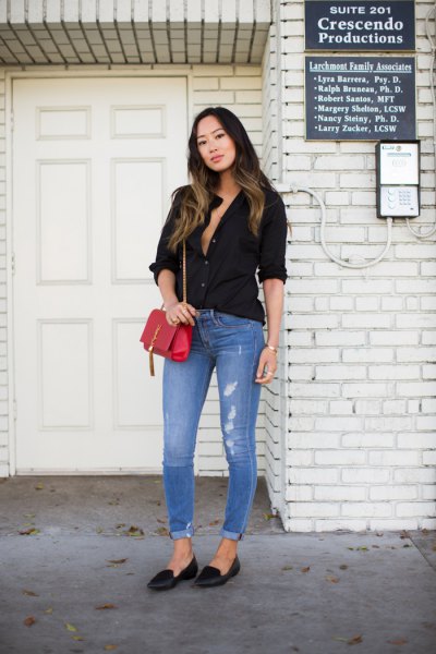 Black button-down shirt with light blue cuffed skinny jeans