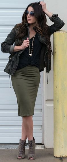 black camouflage jacket with olive green knee length skirt