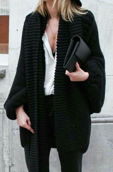 Black chunky knit cable knit cardigan, white blouse and clutch