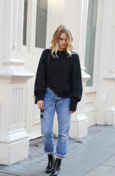 Black chunky knit sweater with cuffed mom jeans