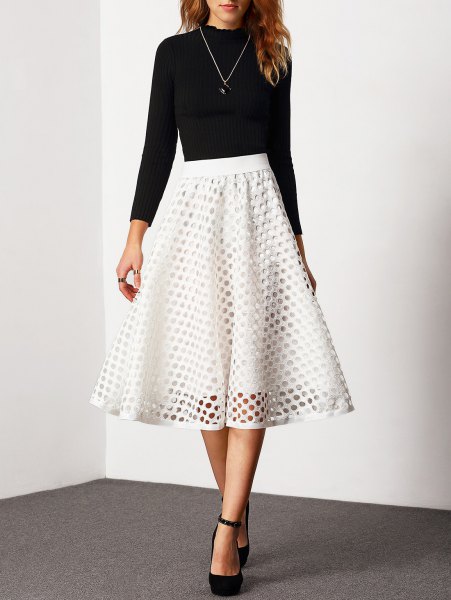 Black fitted crew neck sweater with white semi sheer high waisted flared midi skirt