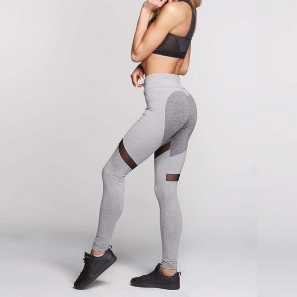Black crop top with light gray athletic leggings and sneakers