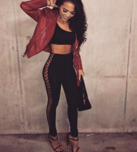 Black crop top with red leather motorcycle jacket and lace-up pants