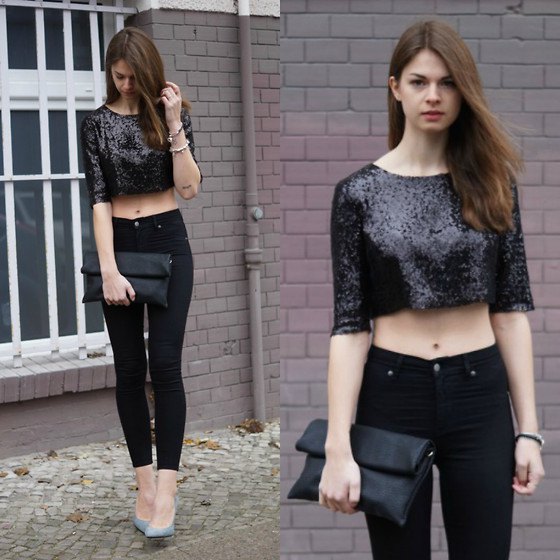 Black, short sequined top with skinny jeans and leather clutch