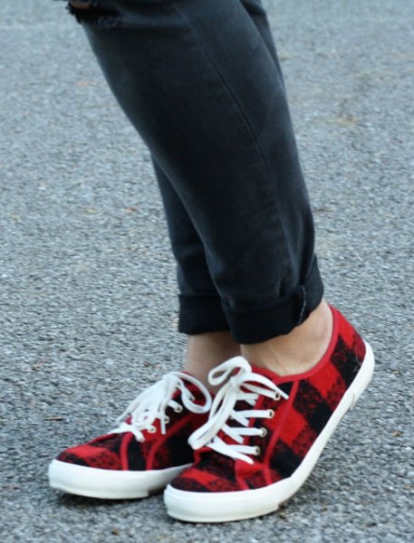 black cuffed jeans and red plaid lace-up plimsolls