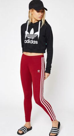 Black graphic cropped hoodie with baseball cap and red and white striped leggings
