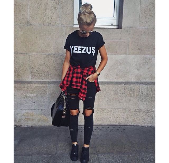 Black graphic t-shirt with ripped jeans and red flannel shirt