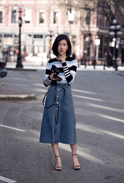 Black gray and white striped sweater with a blue midi skirt with buttons down the front