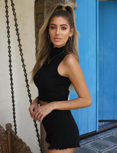 Black halter crop top with scalloped hem and high waisted knit shorts
