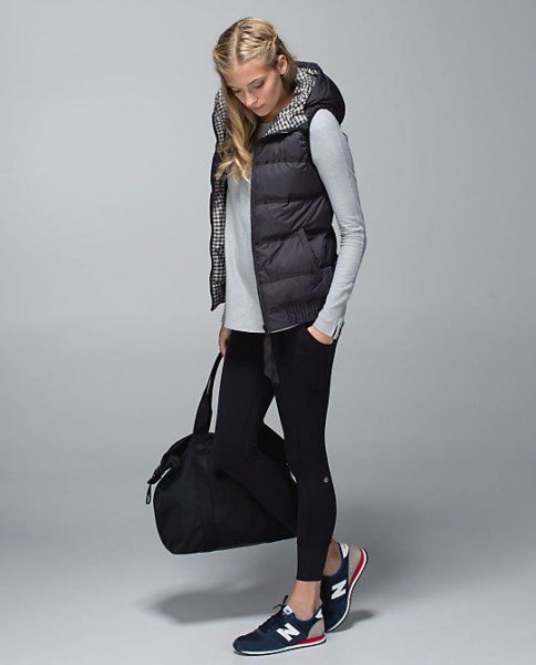 Black quilted vest with a hood, gray fitted long-sleeved t-shirt
and short skinny jeans