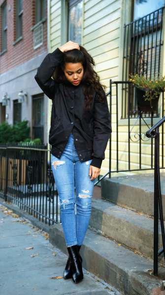 Black jacket with blue high-rise ripped skinny jeans and leather ankle boots
