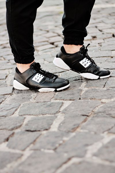 black sweatpants with leather running shoes