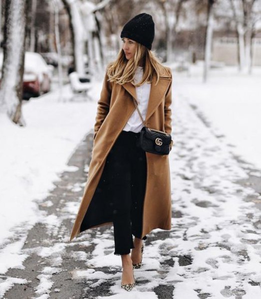 black knit hat with camel wool coat in maxi length and short jeans