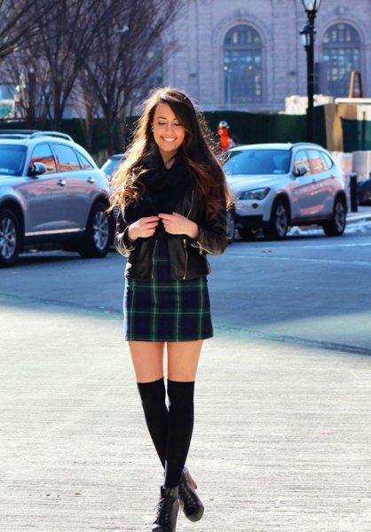 Black leather jacket with a dark blue checked mini skirt and ankle boots