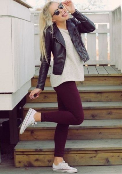 black leather jacket with light pink tunic sweater and leggings