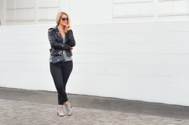 Black leather jacket with a scoop neck t-shirt and gray ankle boots
