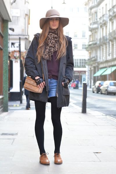 Black long blazer with blue denim mini shorts and brown leather shoes
