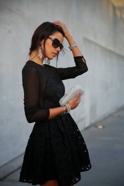 Black long sleeve flared chiffon mini dress with silver clutch handbag