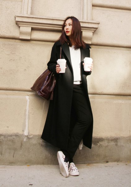 Black long blazer coat with white V-neck sweater and canvas sneakers