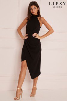 Black halter wrap midi dress with a low back and silver open toe
heels