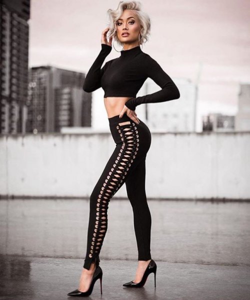 Black, cropped sweater with a stand-up collar and narrow lace-up pants
