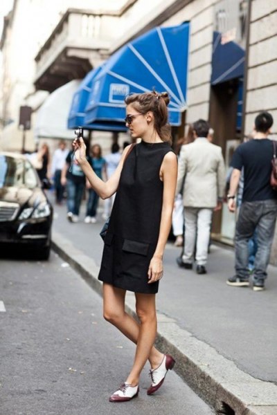 Black high neck mini shift dress with white and gray oxford shoes