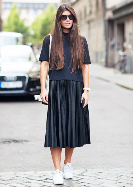 Black short-sleeved sweater with a stand-up collar and a pleated midi skirt
