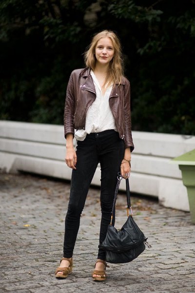 black motorcycle jacket with white linen shirt and brown leather sandals