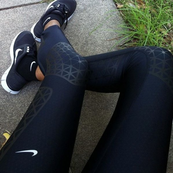 Black Nike sweatpants with matching running shoes