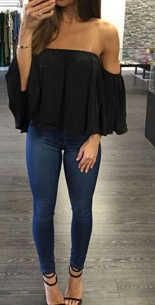 Black off the shoulder chiffon top paired with dark blue super skinny jeans