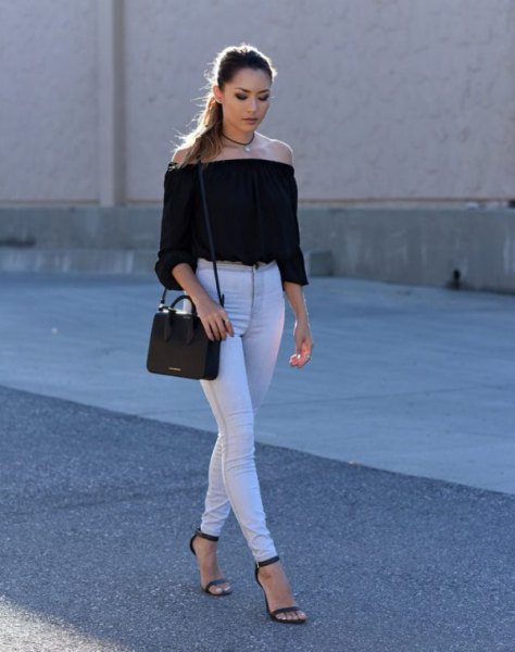 Black off the shoulder cropped blouse paired with high waisted white skinny jeans