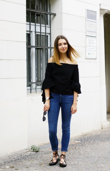 Black off the shoulder blouse with half sleeves and blue skinny
jeans with cuffs