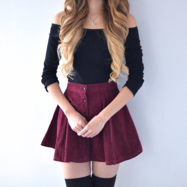 Black off the shoulder sweater with a skater mini skirt buttoned down the front