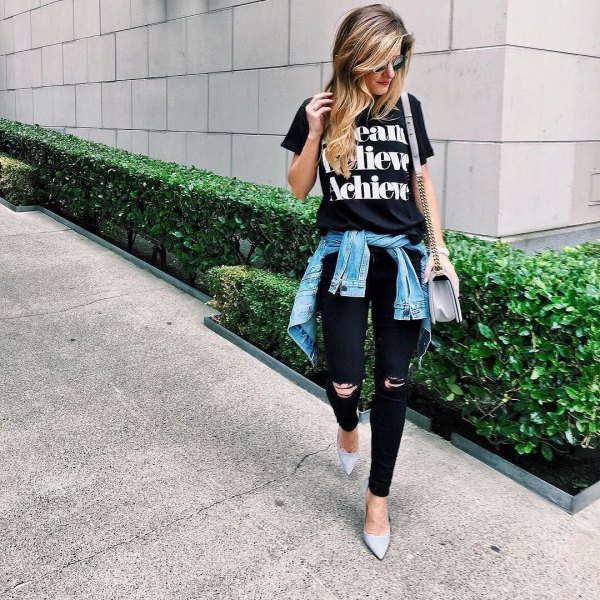 Black printed t-shirt with ripped jeans and denim jacket tied around the waist