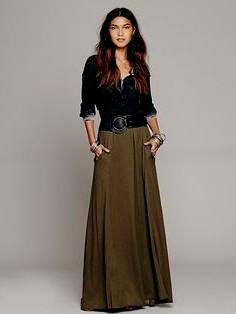 Black scoop neck blouse and green belted maxi skirt