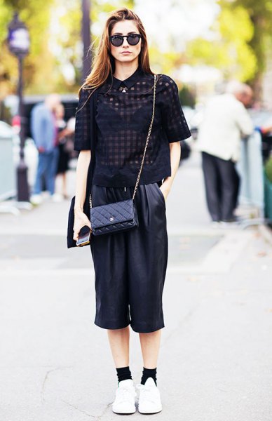 Black, semi-transparent, short-sleeved blouse with cropped, wide-leg leather pants