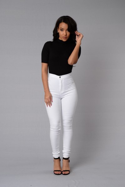 Black high neck short sleeve top with white high waisted skinny jeans