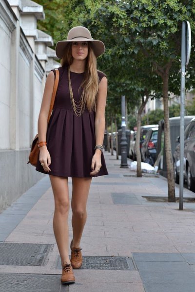 Black sleeveless flared mini dress with pleats and brown oxford shoes