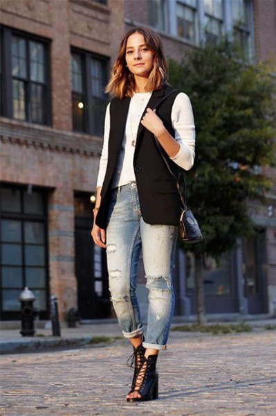 Black sleeveless jacket with white long sleeve t-shirt and cuffed boyfriend jeans