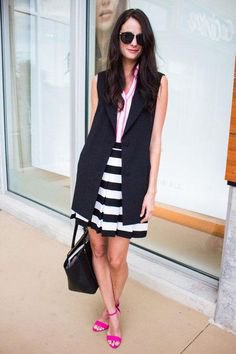 black sleeveless longline blazer with a striped mini skirt and open heels