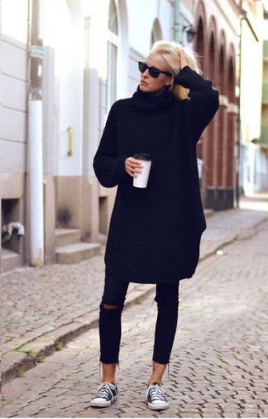 Black sweater dress with ripped short skinny jeans