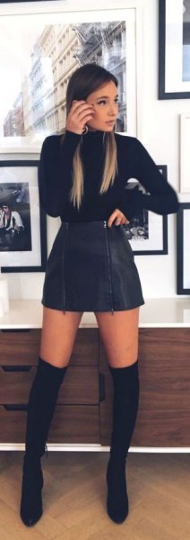 Black sweater with mini suede skater skirt and long boots