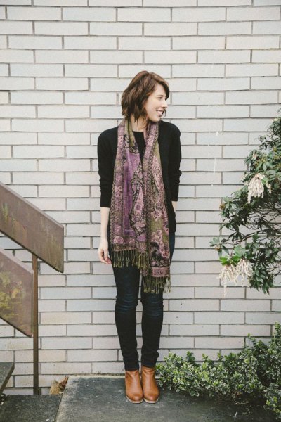 Black sweater with pashmina scarf with tribal pattern and dark skinny jeans