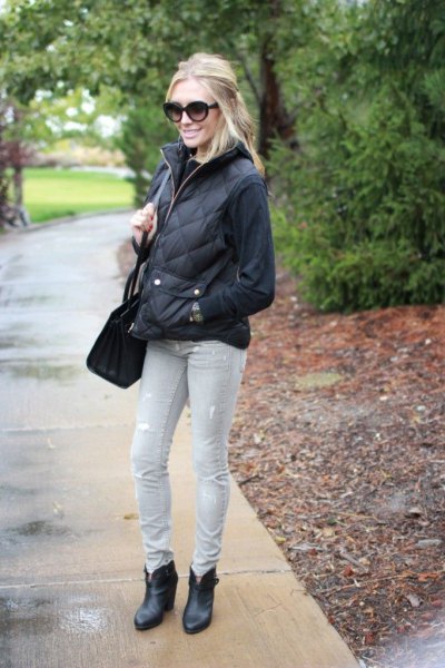 black sweatshirt with quilted puffer jacket and light gray
jeans