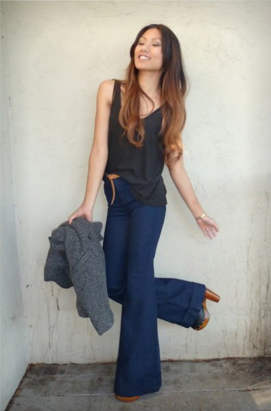 Black tank top with navy high-waisted flared jeans