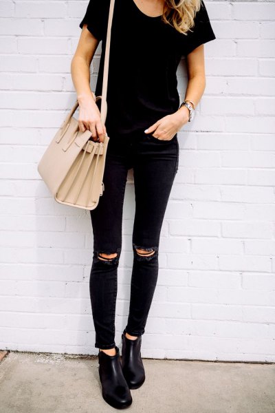 Black t-shirt with ripped knees, matching skinny jeans
