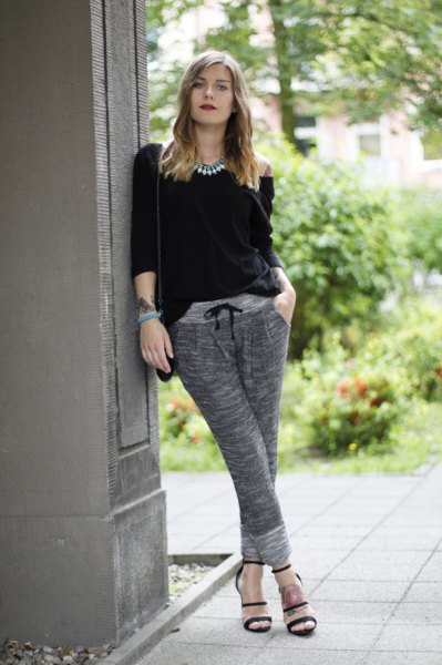 Black top with three-quarter sleeves and gray sweatpants