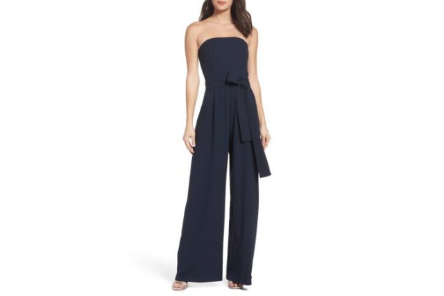 Black drainpipe jumpsuit with tie waist and silver open toe
heels