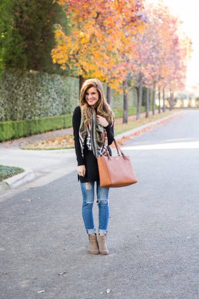 Black tunic sweater with light blue jeans and gray suede ankle boots